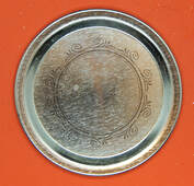 The top of a mason jar lid laying on red craft foam