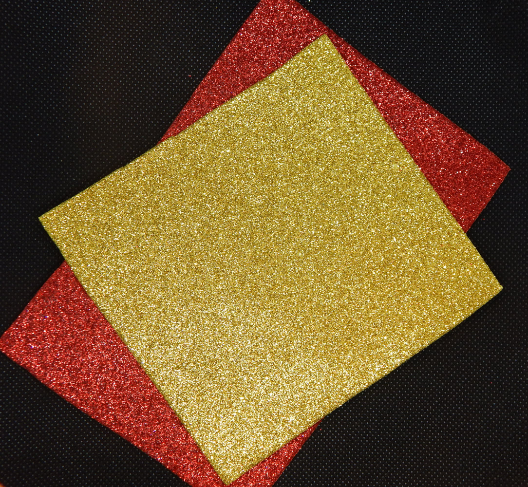 Two pieces of craft foam, one red, one silver, on a black background