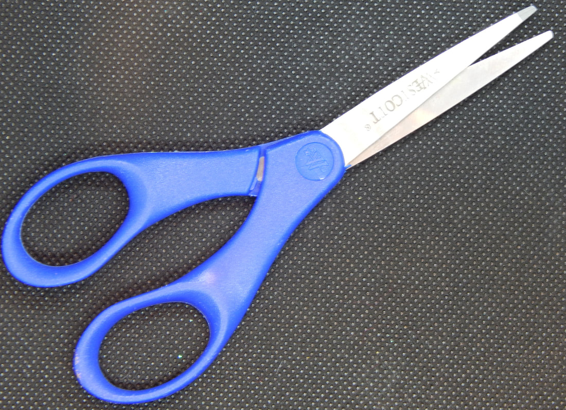 A pair of scissors with pink handles